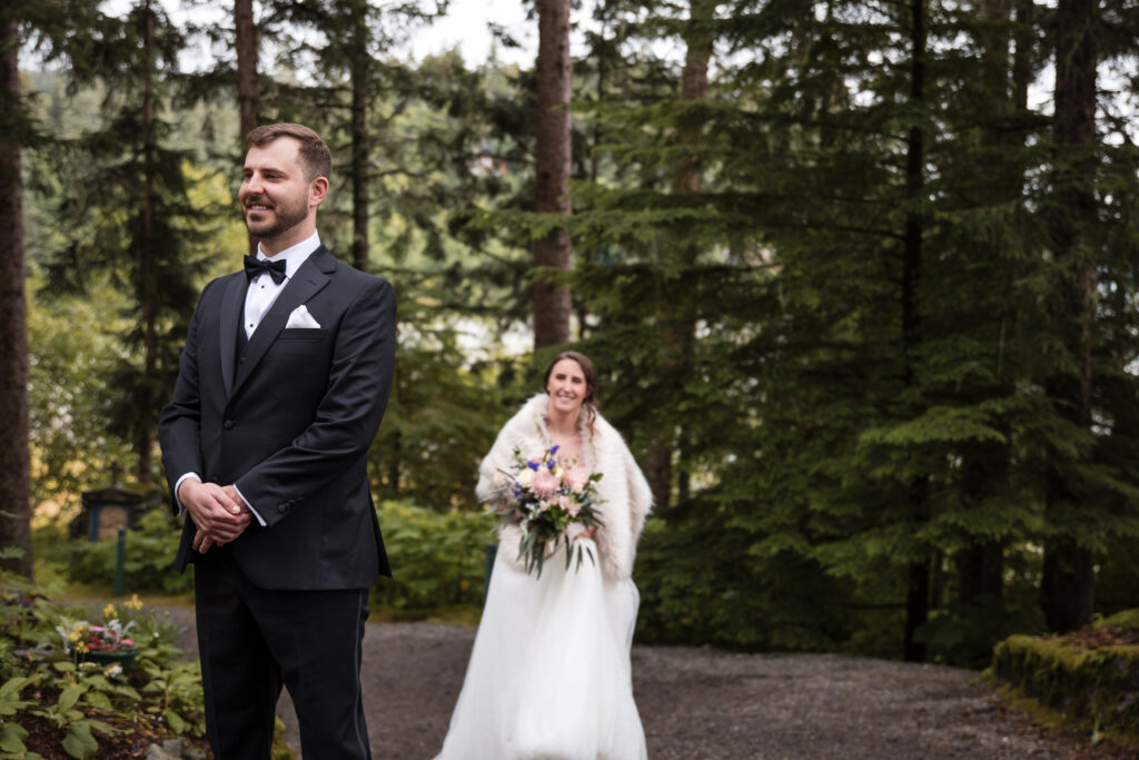 groom waits to see bride for first time during Alaska elopement